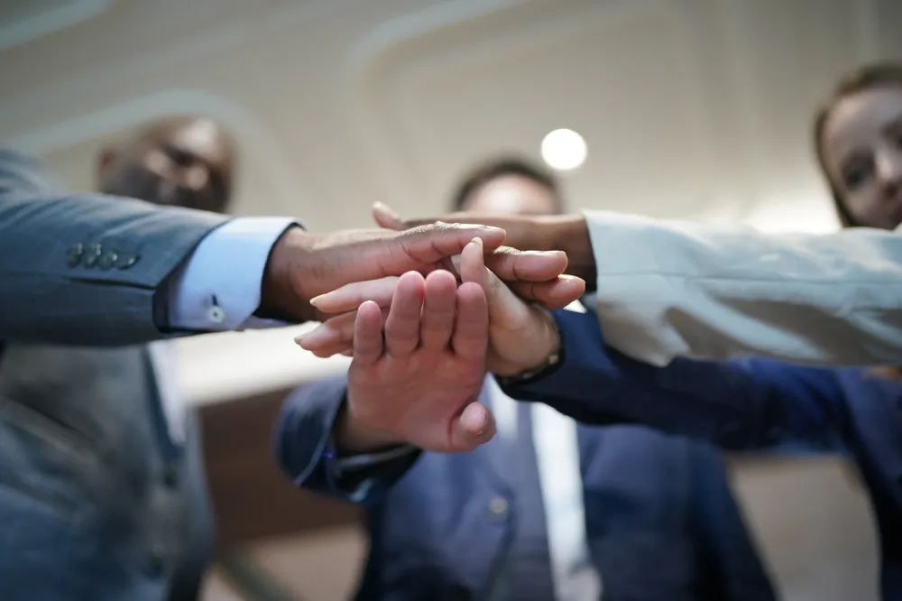 business people stacking hands together